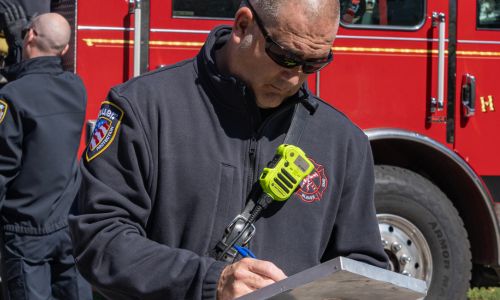 Responder wears the Full Zip Job Shirt outside on a job